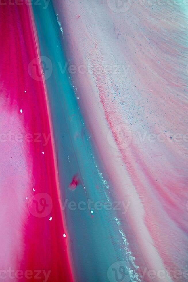 Abstract created using the technique of liquid acrylic. Macro photography of the smallest details of a panting. The panting shows how overflows of shades and colors of paint resemble space motifs. photo