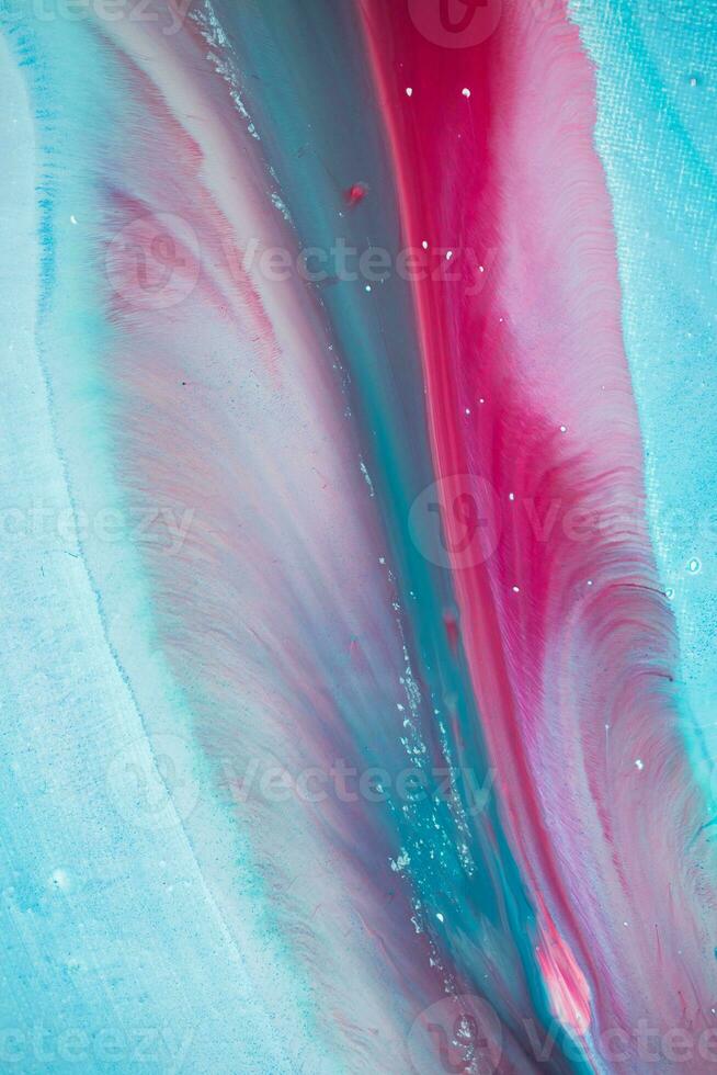 Abstract created using the technique of liquid acrylic. Macro photography of the smallest details of a panting. The panting shows how overflows of shades and colors of paint resemble space motifs. photo
