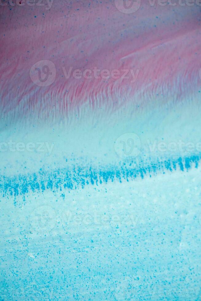 Abstract created using the technique of liquid acrylic. Macro photography of the smallest details of a panting. The panting shows how overflows of shades and colors of paint resemble space motifs. photo