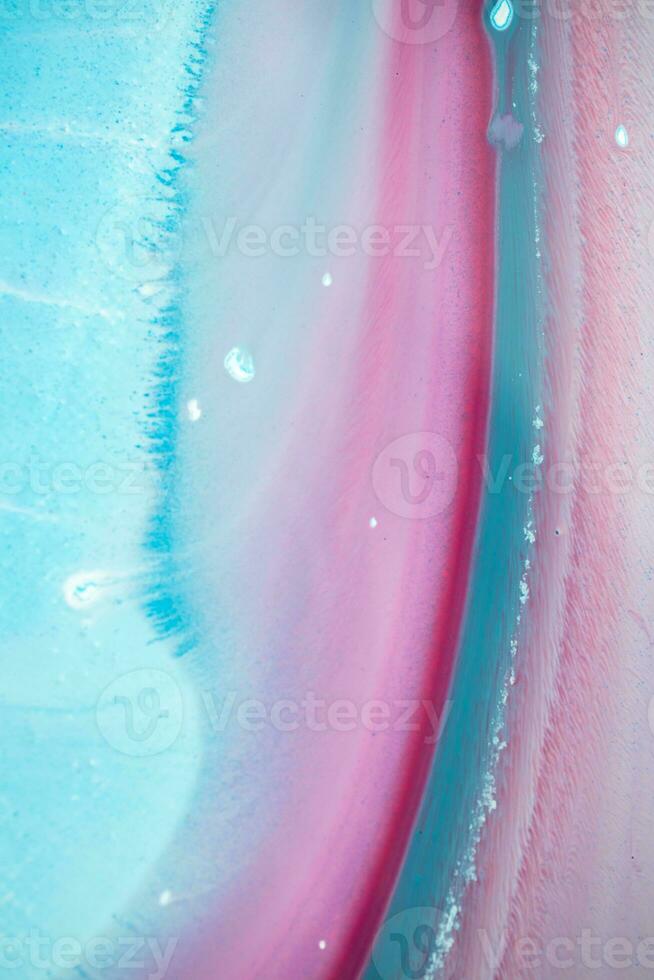 Abstract created using the technique of liquid acrylic. Macro photography of the smallest details of a panting. The panting shows how overflows of shades and colors of paint resemble space motifs. photo