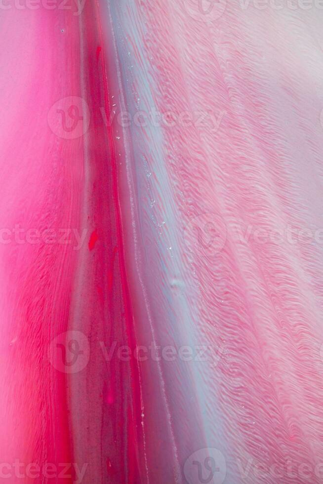 Abstract created using the technique of liquid acrylic. Macro photography of the smallest details of a panting. The panting shows how overflows of shades and colors of paint resemble space motifs. photo