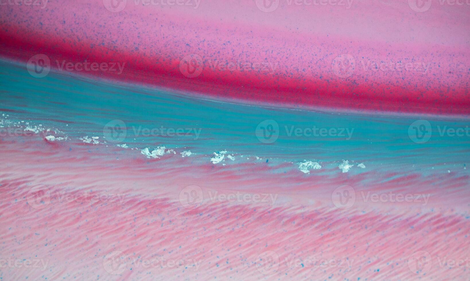 Abstract created using the technique of liquid acrylic. Macro photography of the smallest details of a panting. The panting shows how overflows of shades and colors of paint resemble space motifs. photo