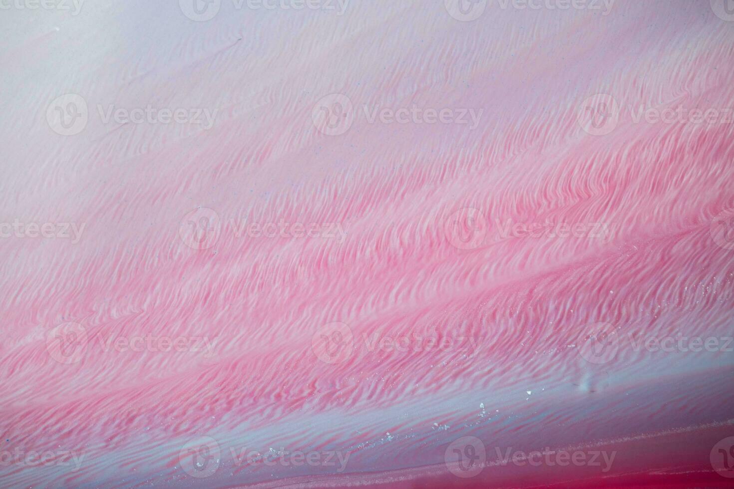 Abstract created using the technique of liquid acrylic. Macro photography of the smallest details of a panting. The panting shows how overflows of shades and colors of paint resemble space motifs. photo