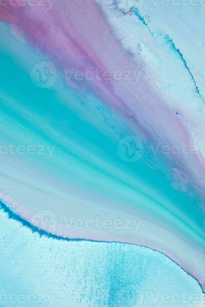 Abstract created using the technique of liquid acrylic. Macro photography of the smallest details of a panting. The panting shows how overflows of shades and colors of paint resemble space motifs. photo