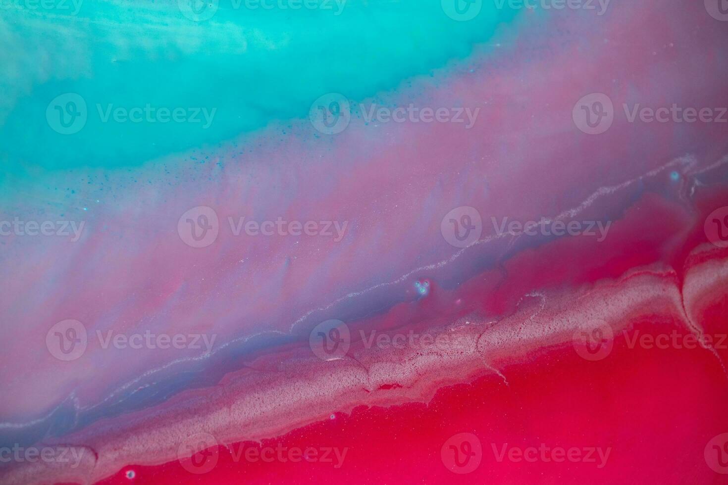 Abstract created using the technique of liquid acrylic. Macro photography of the smallest details of a panting. The panting shows how overflows of shades and colors of paint resemble space motifs. photo