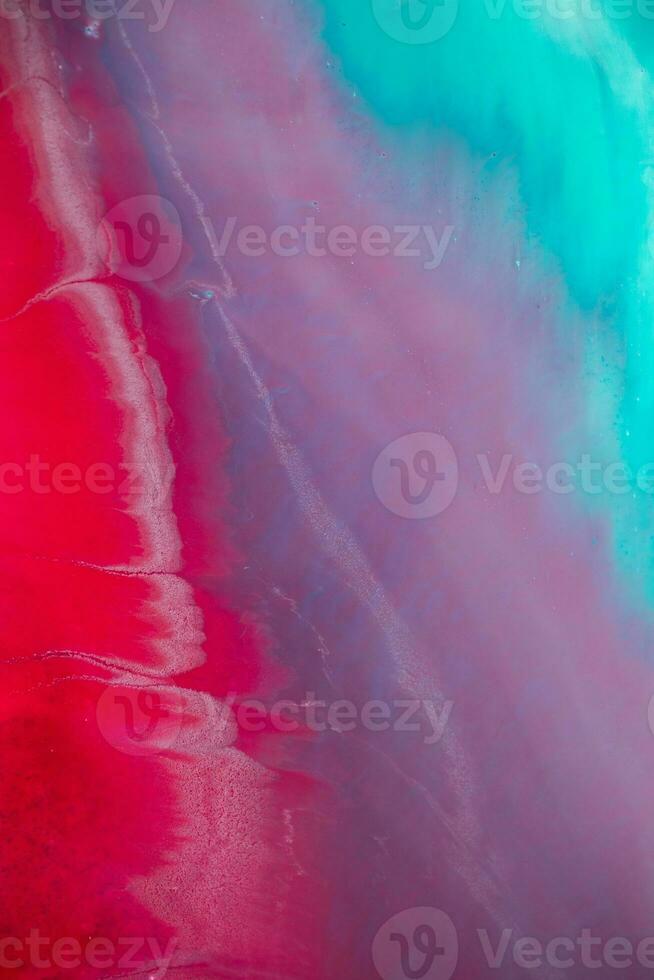 Abstract created using the technique of liquid acrylic. Macro photography of the smallest details of a panting. The panting shows how overflows of shades and colors of paint resemble space motifs. photo