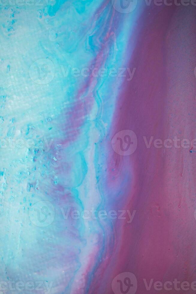 Abstract created using the technique of liquid acrylic. Macro photography of the smallest details of a panting. The panting shows how overflows of shades and colors of paint resemble space motifs. photo