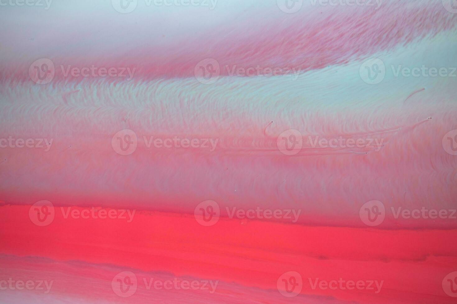 Abstract created using the technique of liquid acrylic. Macro photography of the smallest details of a panting. The panting shows how overflows of shades and colors of paint resemble space motifs. photo