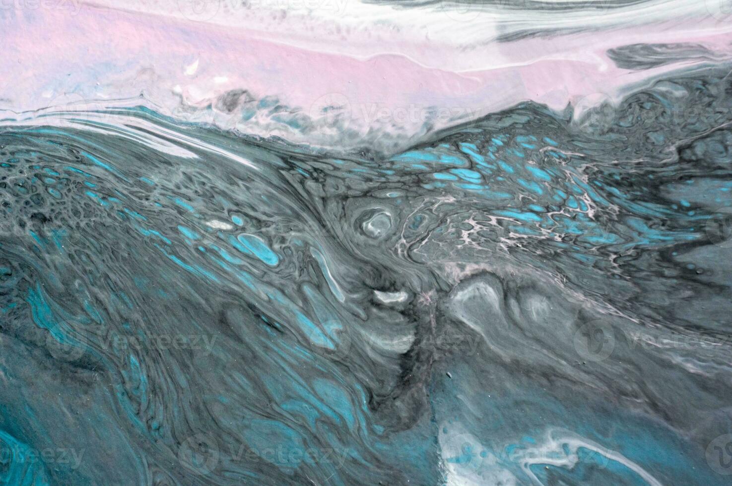 Abstract created using the technique of liquid acrylic. Macro photography of the smallest details of a picture. The picture shows how overflows of shades and colors of paint resemble space motifs. photo