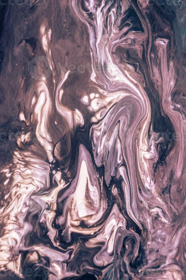Abstract created using the technique of liquid acrylic. Macro photography of the smallest details of a picture. The picture shows how overflows of shades and colors of paint resemble space motifs. photo