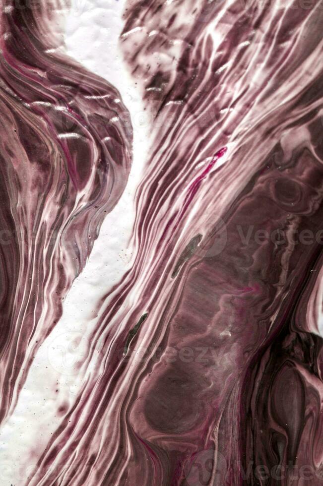 Abstract created using the technique of liquid acrylic. Macro photography of the smallest details of a picture. The picture shows how overflows of shades and colors of paint resemble space motifs. photo