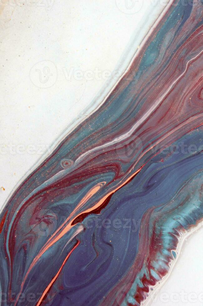 Abstract created using the technique of liquid acrylic. Macro photography of the smallest details of a panting. The panting shows how overflows of shades and colors of paint resemble space motifs. photo