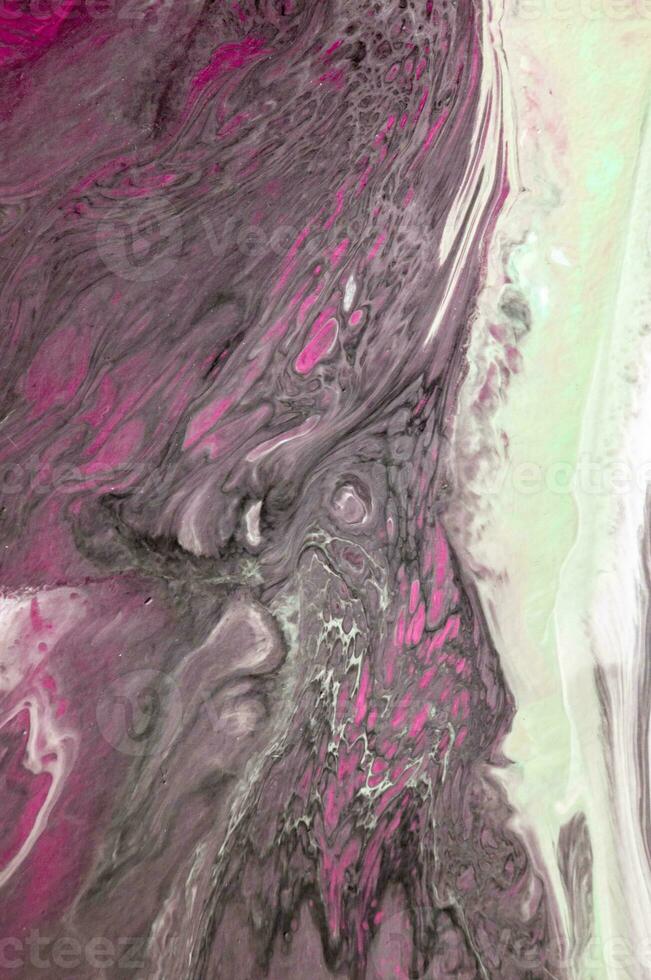 Abstract created using the technique of liquid acrylic. Macro photography of the smallest details of a picture. The picture shows how overflows of shades and colors of paint resemble space motifs. photo
