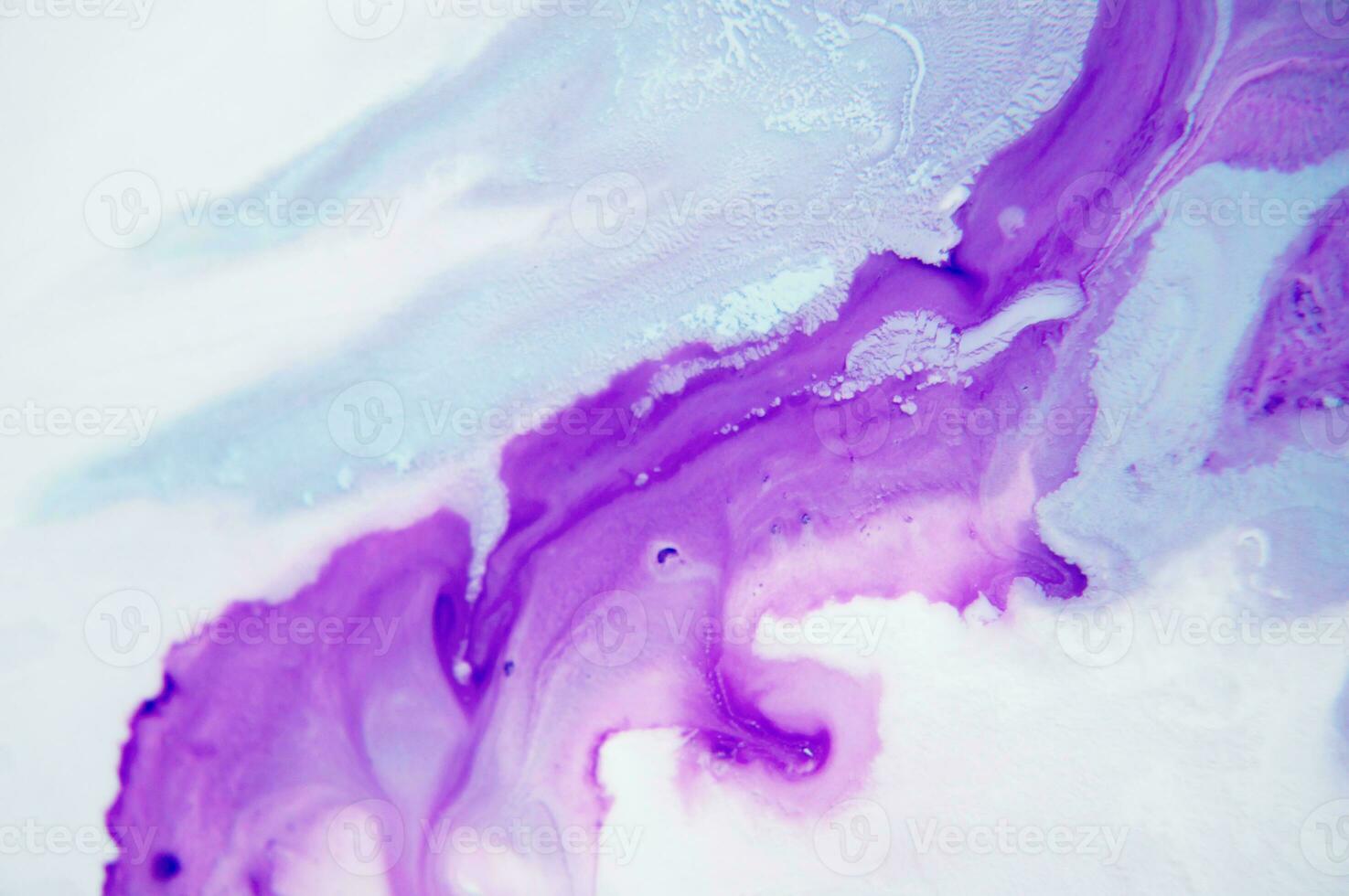 Abstract created using the technique of liquid acrylic. Macro photography of the smallest details of a panting. The panting shows how overflows of shades and colors of paint resemble space motifs. photo