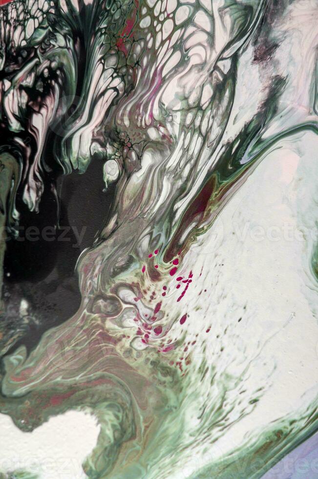 Abstract created using the technique of liquid acrylic. Macro photography of the smallest details of a picture. The picture shows how overflows of shades and colors of paint resemble space motifs. photo