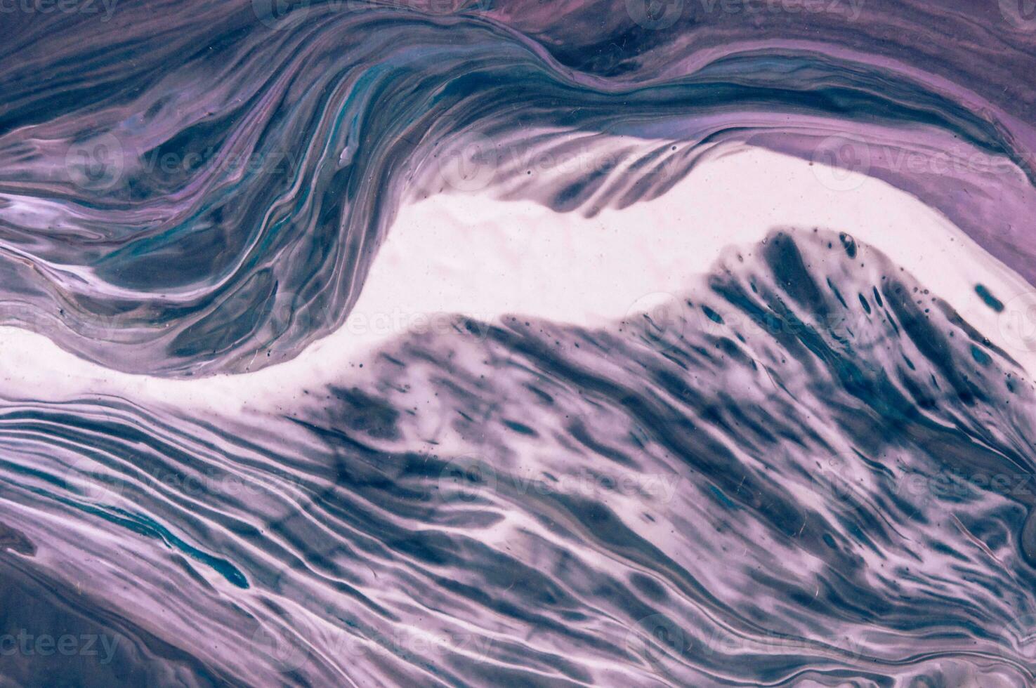 Abstract created using the technique of liquid acrylic. Macro photography of the smallest details of a picture. The picture shows how overflows of shades and colors of paint resemble space motifs. photo