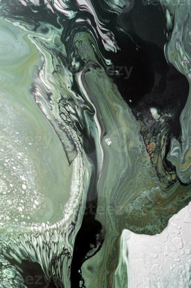 Abstract created using the technique of liquid acrylic. Macro photography of the smallest details of a picture. The picture shows how overflows of shades and colors of paint resemble space motifs. photo
