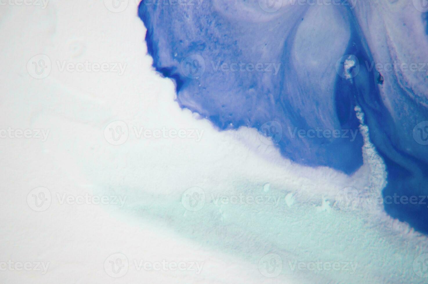 Abstract created using the technique of liquid acrylic. Macro photography of the smallest details of a panting. The panting shows how overflows of shades and colors of paint resemble space motifs. photo