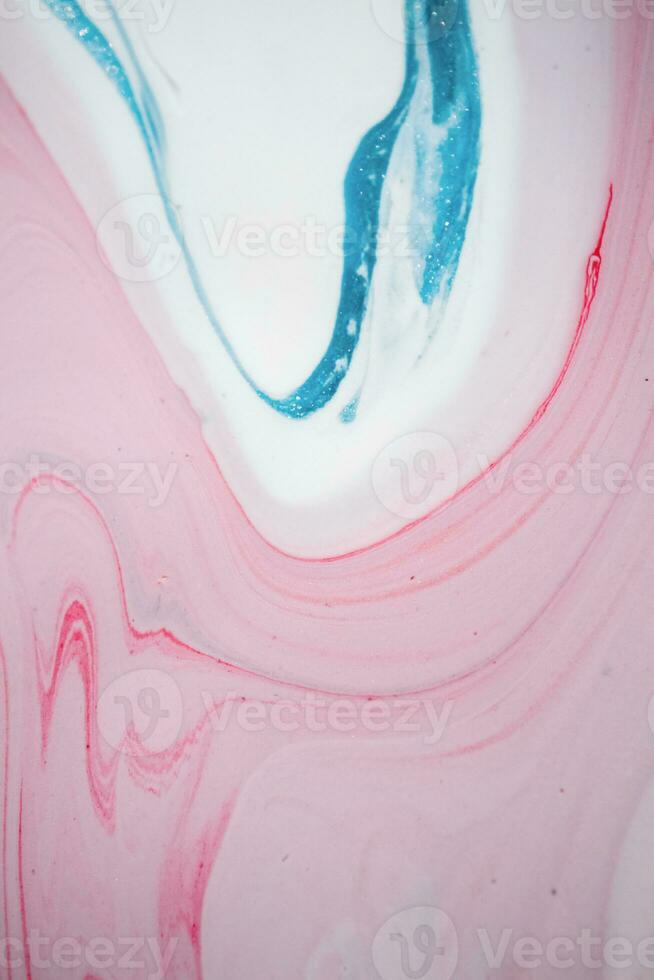 Abstract created using the technique of liquid acrylic. Macro photography of the smallest details of a picture. The picture shows how overflows of shades and colors of paint resemble space motifs. photo