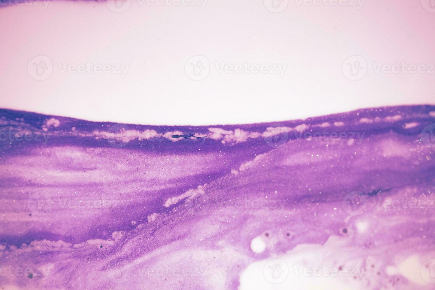 Abstract created using the technique of liquid acrylic. Macro photography of the smallest details of a picture. The picture shows how overflows of shades and colors of paint resemble space motifs. photo