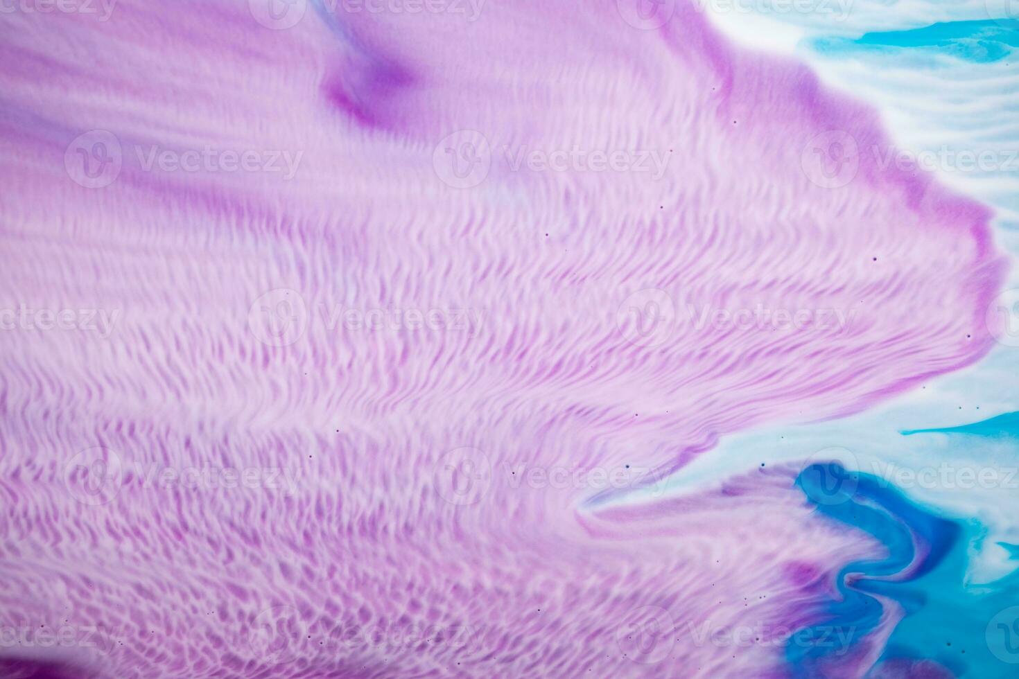 Abstract created using the technique of liquid acrylic. Macro photography of the smallest details of a picture. The picture shows how overflows of shades and colors of paint resemble space motifs. photo
