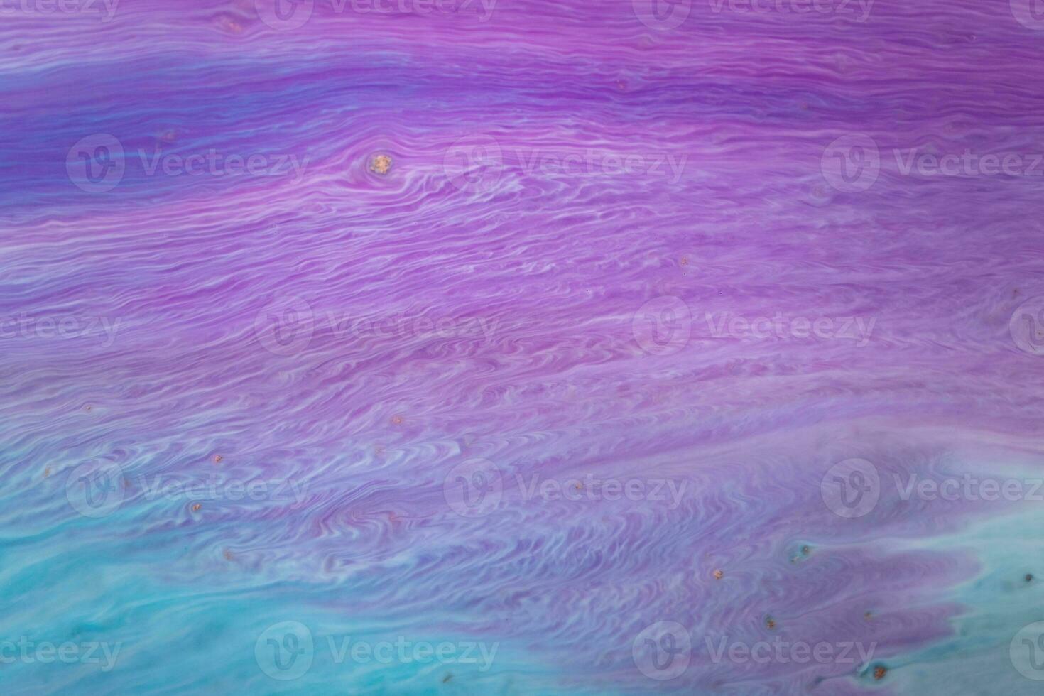 Abstract created using the technique of liquid acrylic. Macro photography of the smallest details of a picture. The picture shows how overflows of shades and colors of paint resemble space motifs. photo