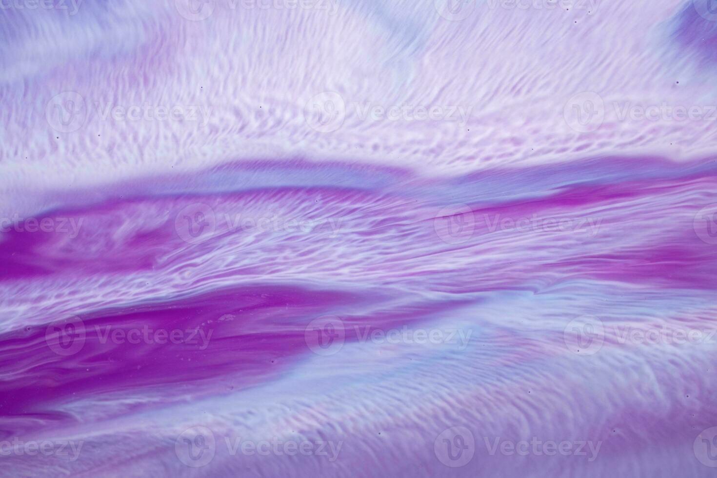 Abstract created using the technique of liquid acrylic. Macro photography of the smallest details of a picture. The picture shows how overflows of shades and colors of paint resemble space motifs. photo