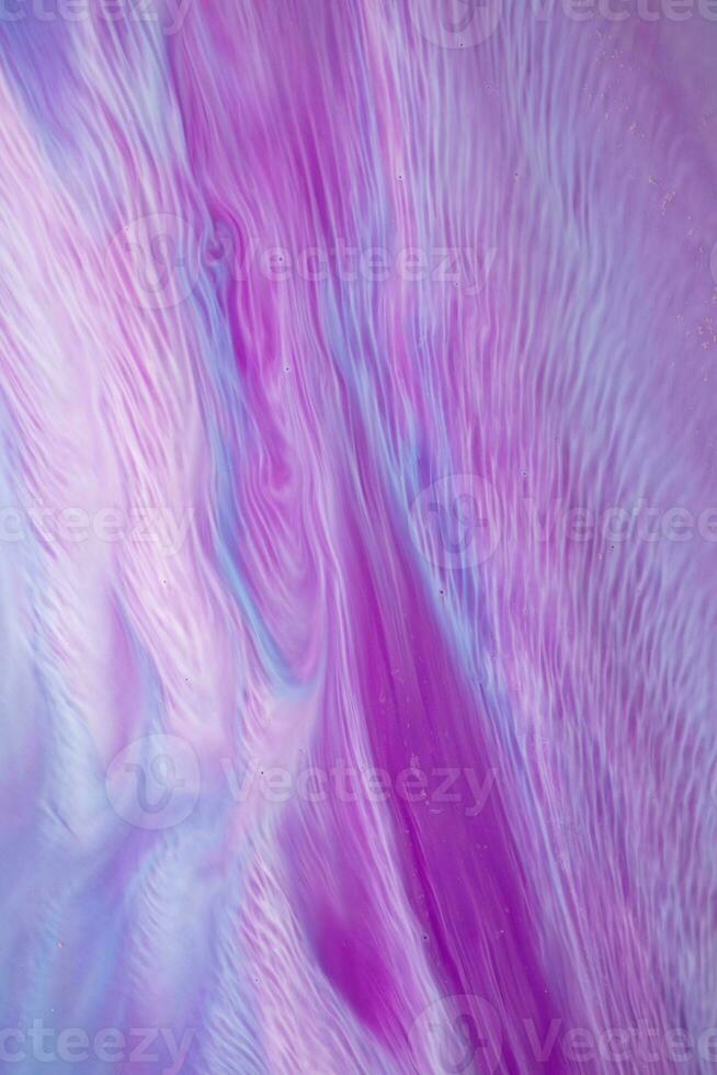 Abstract created using the technique of liquid acrylic. Macro photography of the smallest details of a picture. The picture shows how overflows of shades and colors of paint resemble space motifs. photo