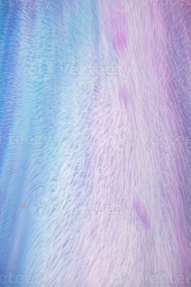 Abstract created using the technique of liquid acrylic. Macro photography of the smallest details of a picture. The picture shows how overflows of shades and colors of paint resemble space motifs. photo