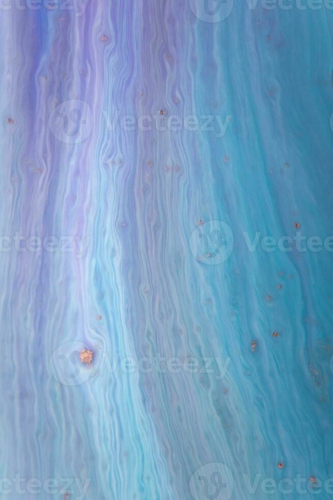 Abstract created using the technique of liquid acrylic. Macro photography of the smallest details of a picture. The picture shows how overflows of shades and colors of paint resemble space motifs. photo