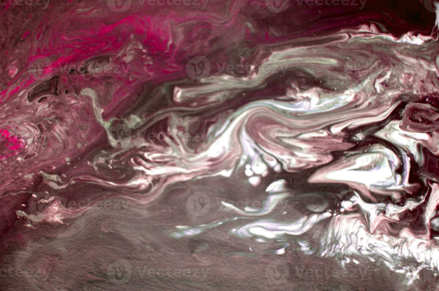 Abstract created using the technique of liquid acrylic. Macro photography of the smallest details of a picture. The picture shows how overflows of shades and colors of paint resemble space motifs. photo