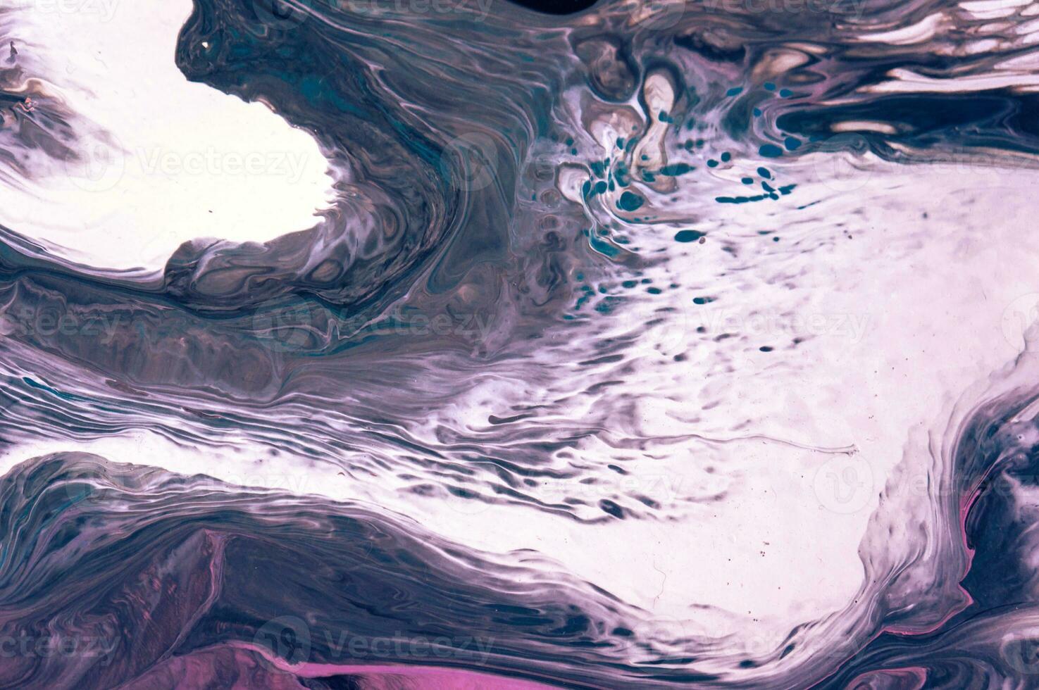 Abstract created using the technique of liquid acrylic. Macro photography of the smallest details of a picture. The picture shows how overflows of shades and colors of paint resemble space motifs. photo