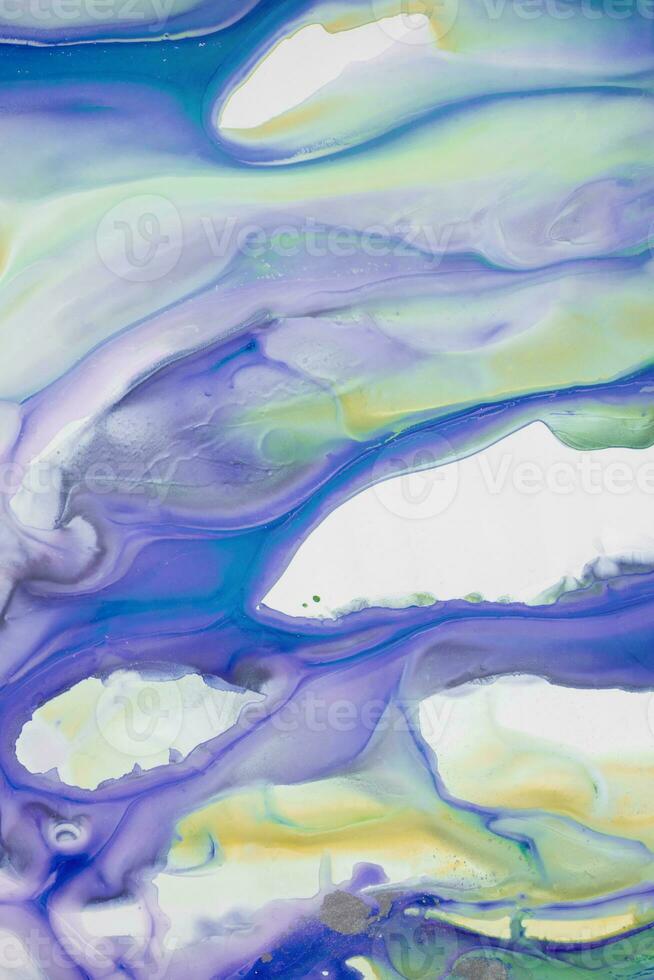 Abstract created using the technique of liquid acrylic. Macro photography of the smallest details of a picture. The picture shows how overflows of shades and colors of paint resemble space motifs. photo