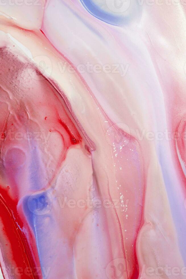 Abstract created using the technique of liquid acrylic. Macro photography of the smallest details of a picture. The picture shows how overflows of shades and colors of paint resemble space motifs. photo