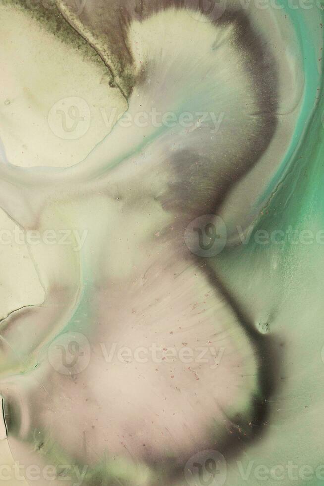 Abstract created using the technique of liquid acrylic. Macro photography of the smallest details of a picture. The picture shows how overflows of shades and colors of paint resemble space motifs. photo