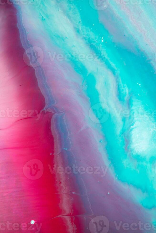 Abstract created using the technique of liquid acrylic. Macro photography of the smallest details of a panting. The panting shows how overflows of shades and colors of paint resemble space motifs. photo