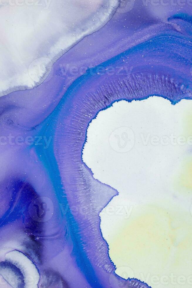 Abstract created using the technique of liquid acrylic. Macro photography of the smallest details of a picture. The picture shows how overflows of shades and colors of paint resemble space motifs. photo
