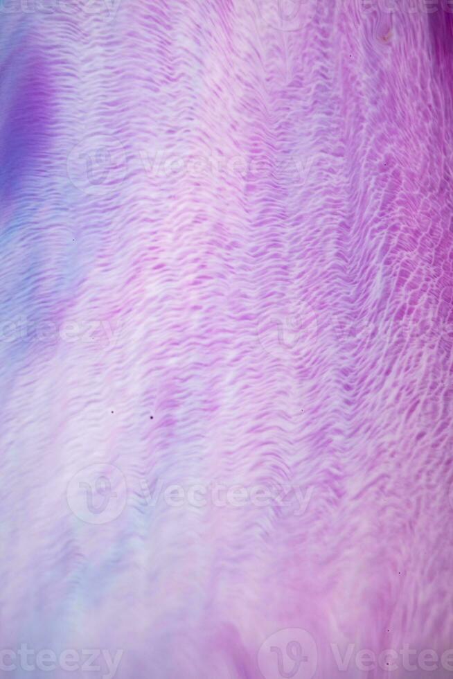 Abstract created using the technique of liquid acrylic. Macro photography of the smallest details of a picture. The picture shows how overflows of shades and colors of paint resemble space motifs. photo