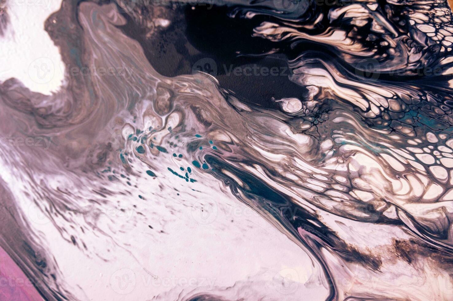 Abstract created using the technique of liquid acrylic. Macro photography of the smallest details of a picture. The picture shows how overflows of shades and colors of paint resemble space motifs. photo