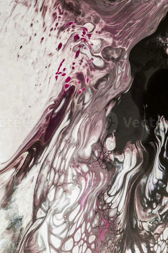 Abstract created using the technique of liquid acrylic. Macro photography of the smallest details of a picture. The picture shows how overflows of shades and colors of paint resemble space motifs. photo