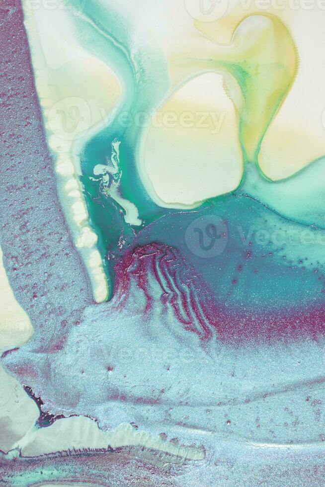Abstract created using the technique of liquid acrylic. Macro photography of the smallest details of a picture. The picture shows how overflows of shades and colors of paint resemble space motifs. photo