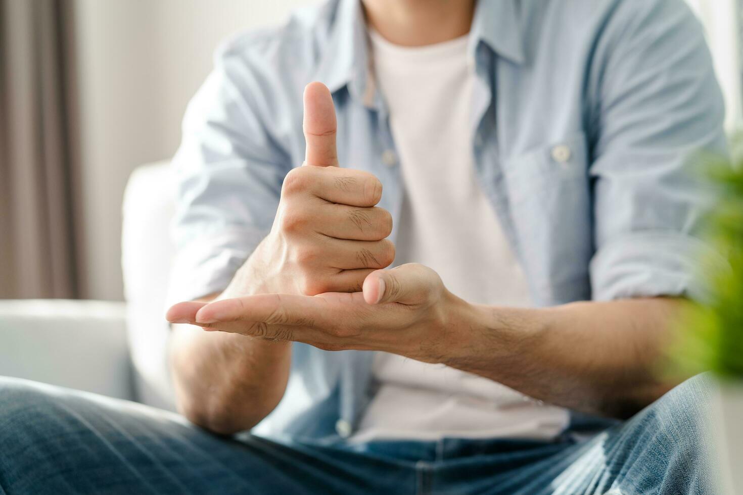 Happy young deaf man using sign Language to communicate with other people. photo