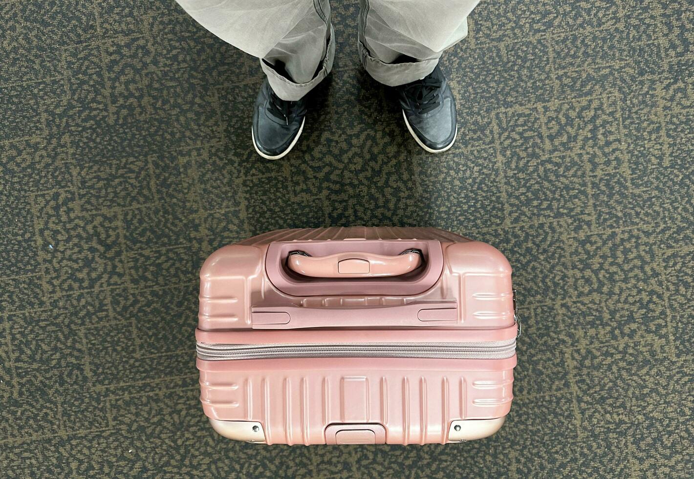 Top view plastic case and blackshoe  Plastic impact-resistant suitcase for transporting  Case  Plastic box lid top view. Transport box on ground  traveler wheeling his big and heavy luggage photo