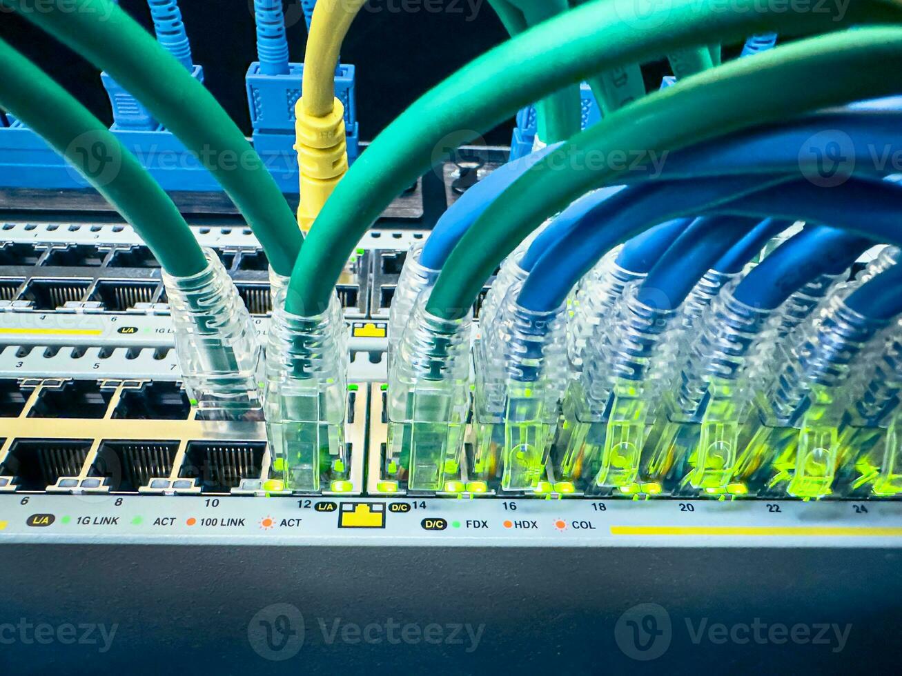 Network communication equipment in the datacenter in the server rack with fiber optic hub for digital communications and internet.And Cables in Big Data Center. Connecting Lan Cable To Mainframe photo
