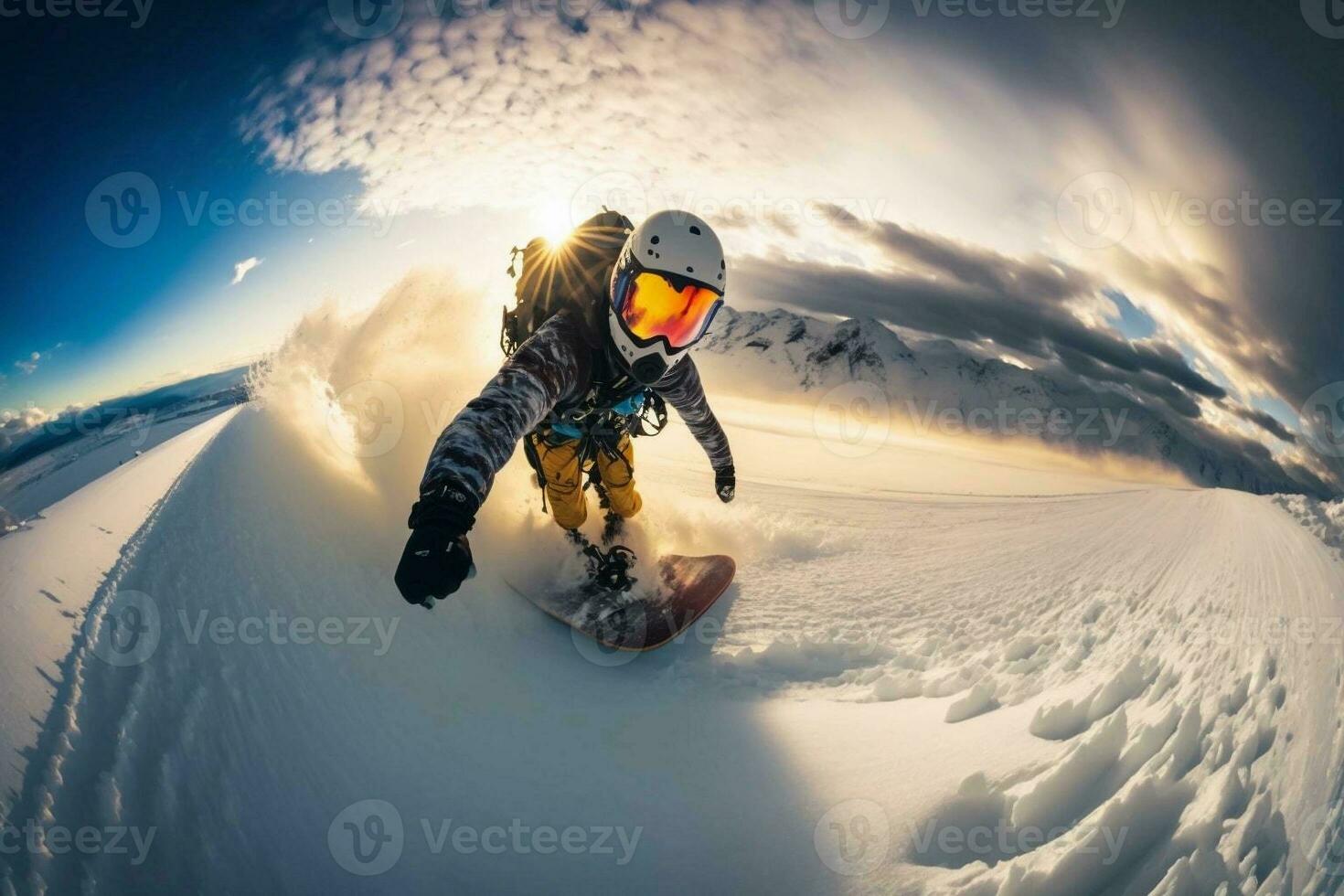 A young man on a snowboard rushes at great speed from a snowy mountain. Extreme sport. Go pro wide angle shot. photo