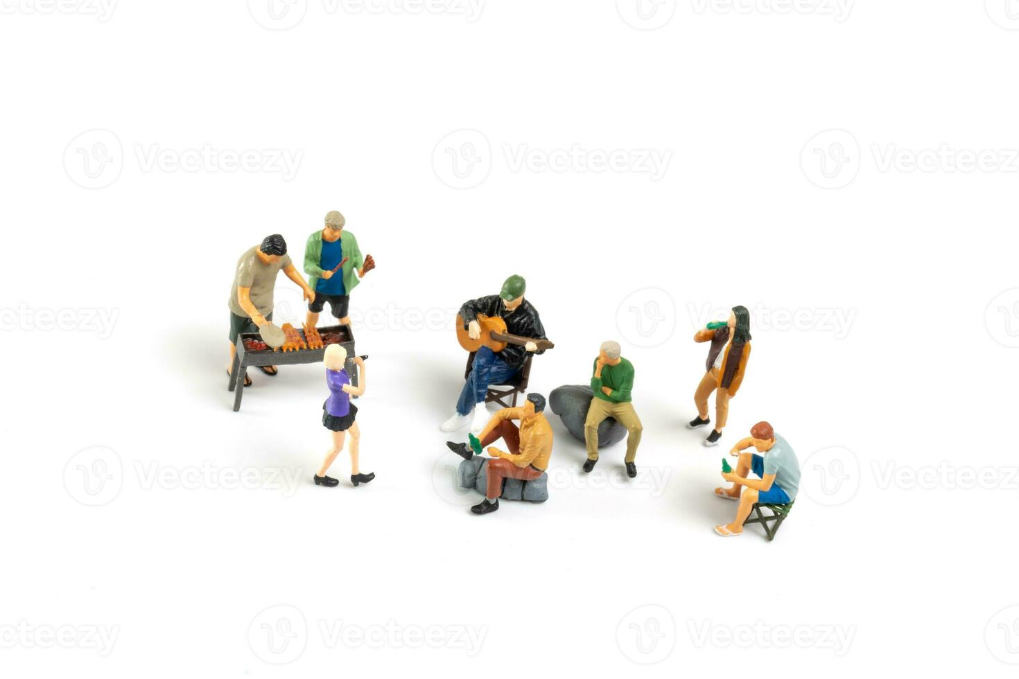 Miniature people are making barbeque, drinking beverages isolated on white background photo