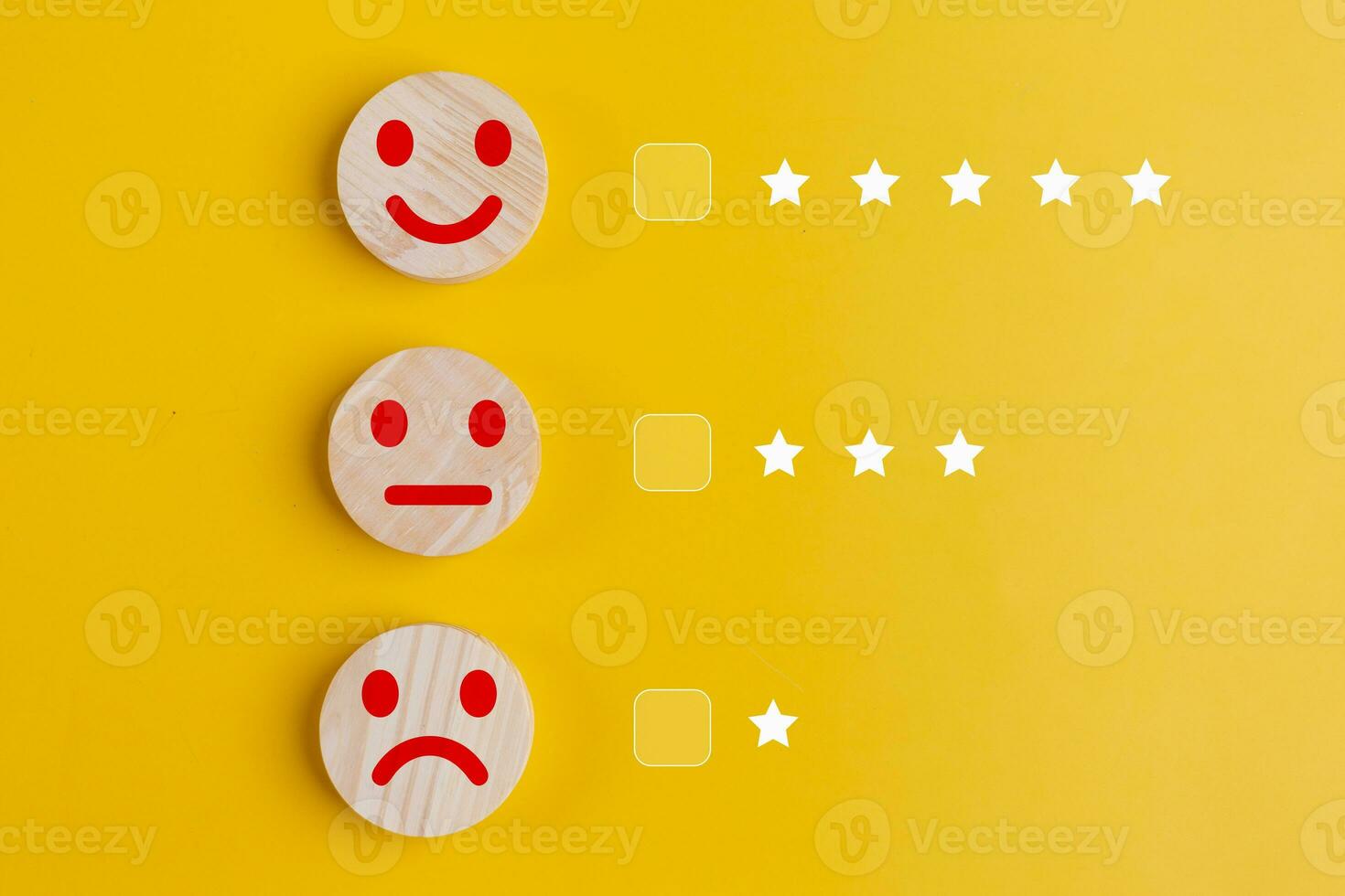 Customer reviews concept. Wooden buttons with smiley faces on a yellow background photo