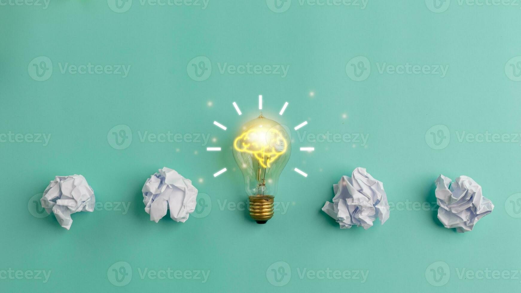 Idea concept with crumpled paper and a light bulb on a blue background. Creative thinking ideas and innovation concepts. photo