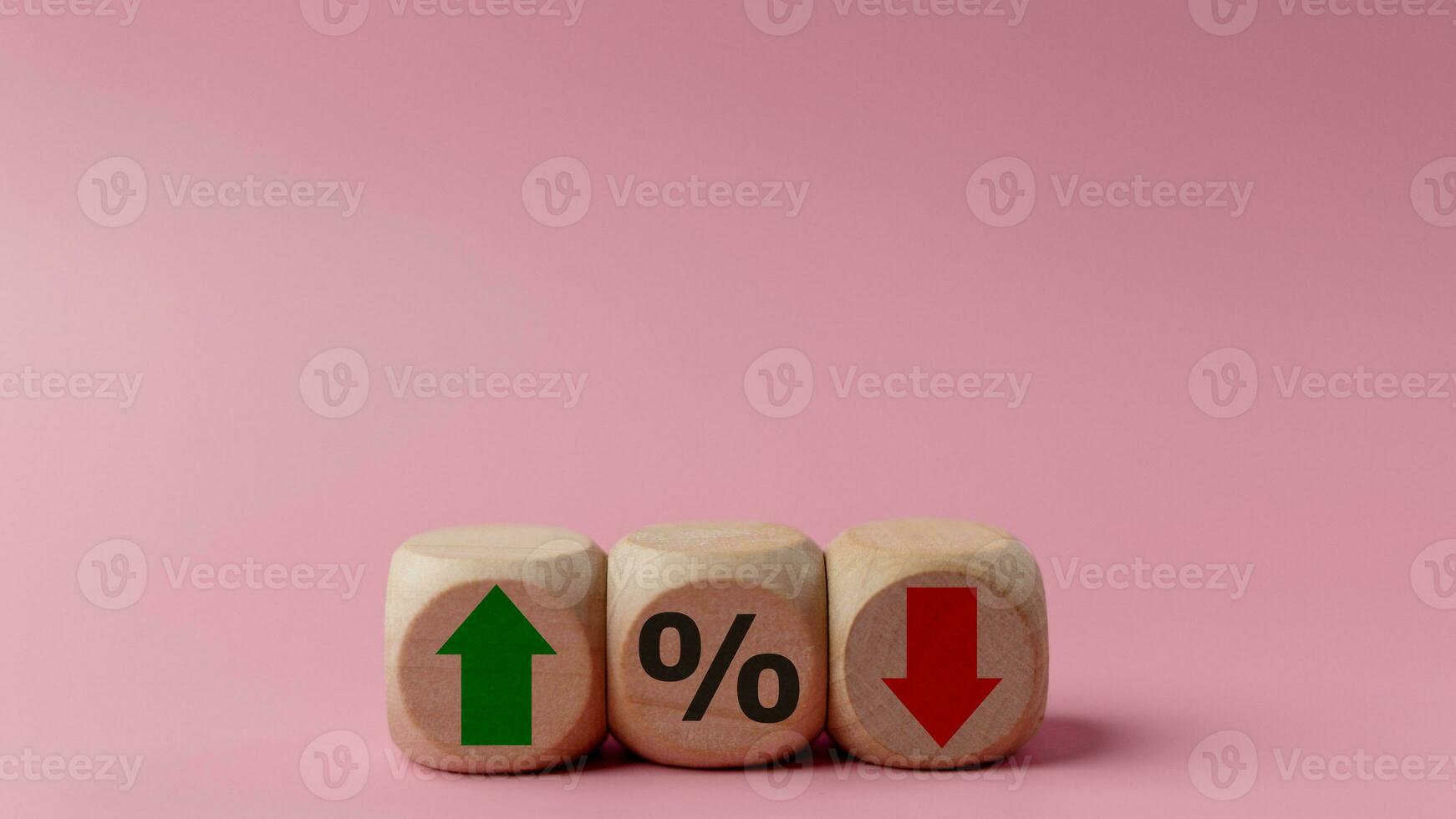 Wooden cubes with green arrow and red arrow with icon percentage symbol on pink background. Interest rate financial and mortgage rates concept. photo