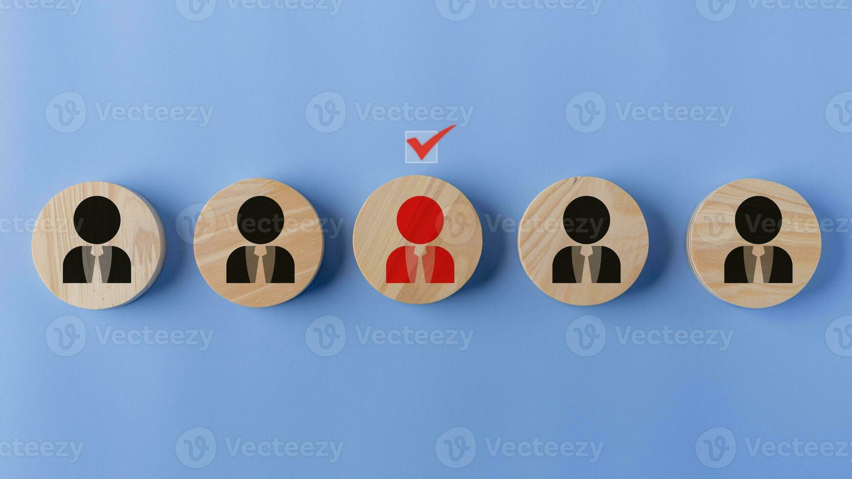 Wooden figures of people on a blue background with a red check mark. Online recruitment application specialist search service concept photo